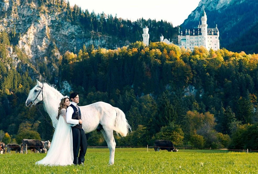 Bavaria Neuschwanstein Castle - This is where romance and fantasy meet. If it weren’t for the cows grazing in the middle-ground, we might think this was a Disney Cel Painting for the latest Cinderella movie. Seemingly a dream, but somehow real life.