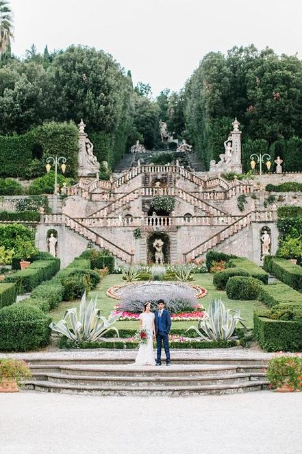 Photo by: Maria Lamb Photography - Vittoriale degli Italiani, built in the early 1900’s by beloved Italian poet Gabriele d’Annunzio, is the spot to be for an enchanting experience. Centered right under these eye-catching, formidable sculptures, the couple’s stance is striking in simplicity against the staggering embellishments of this formal garden.