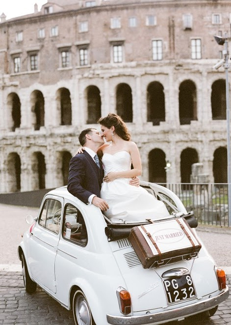 Photo by: Rochelle Cheever - True love is posing in front of the Coliseum and being captivated only by your beau! Let your guests “Oh” and “Ah” at these beautiful moments, while you look on with a cheeky smile knowing that your lover was the only thing catching your eye that day.