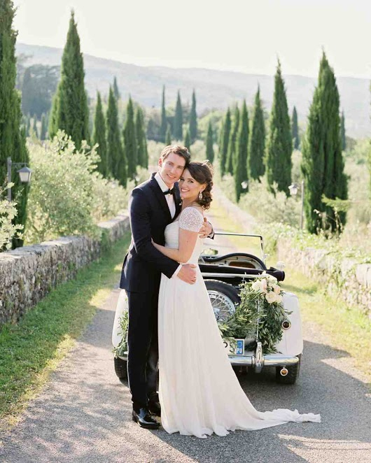 Photo by: Polly Alexandre - This photo is for the type-A personality. Every detail has been accounted for, from the trimmed trees to the white roses and fresh ferns scalloping this polished convertible. So much beauty and wonder can surely only be home to the heavens.